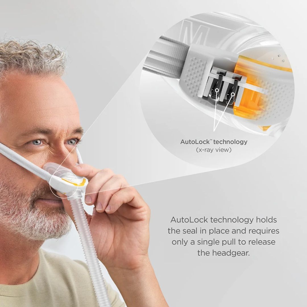 Person demonstrating the Fisher & Paykel F&P Solo Nasal Pillow CPAP Mask with AutoFit headgear and AutoLock technology, showing how the mask maintains a secure seal for effective sleep apnea therapy.